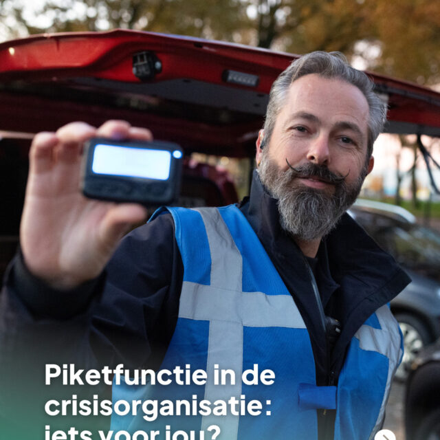 man die recht in de camera kijkt en een tweewegpager toont